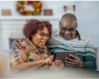 Seniors looking at a tablet together that links to a detailed Book-a-Librarian webpage